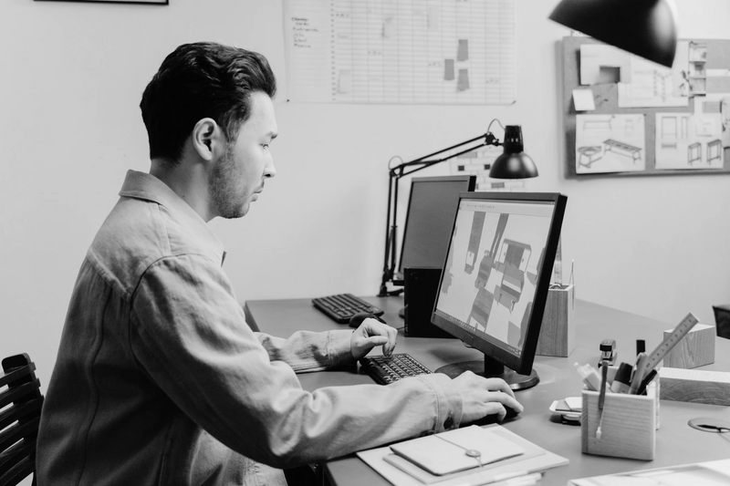Richard Marin at the drawing board in the studio, black and white